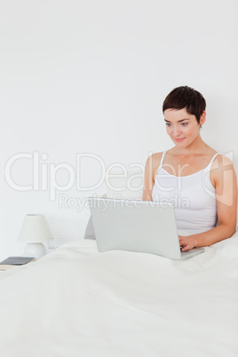Portait of a brunette woman using a laptop