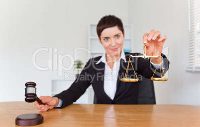 Professional woman with a gavel and the justice scale