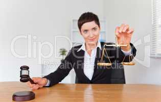 Professional woman with a gavel and the justice scale