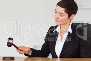 Serious woman knocking a gavel