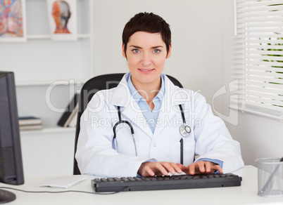 Female doctor typing with her computer