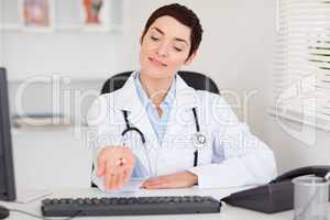 Female doctor showing pills