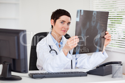 Professional female doctor holding a set of X-ray