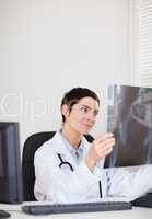 Focused female doctor looking at X-ray