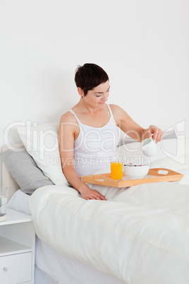 Portrait of a young woman having breakfast