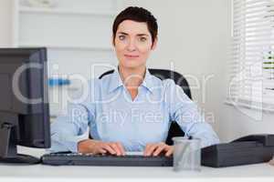Portrait of a businesswoman typing with her computer