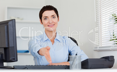 Smiling business woman giving her hand