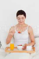 Gorgeous woman eating cereal