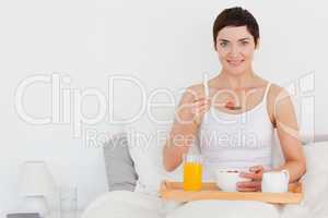 Charming woman eating cereal
