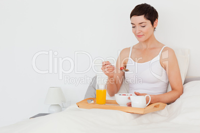 Good looking woman eating cereals