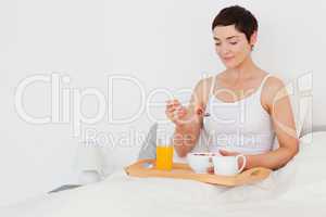 Good looking woman eating cereals