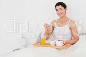 Dark-haired woman having breakfast