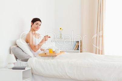 Good looking woman eating breakfast