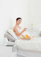 Portrait of a woman eating breakfast