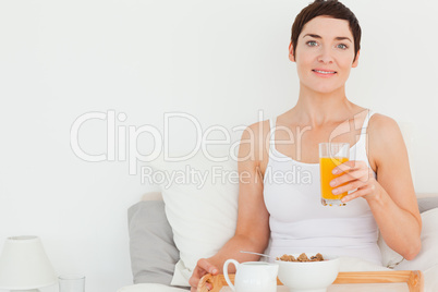 Close up of a woman drinking orange juice