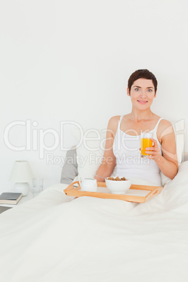 Portrait of a woman holding a glass of juice