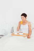 Woman drinking juice for breakfast
