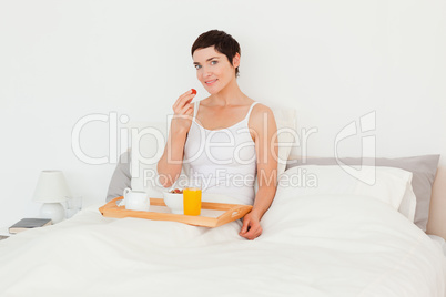 Young woman eating a strawberry