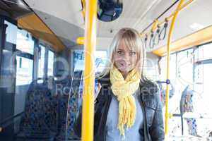 blond woman stands inside a bus