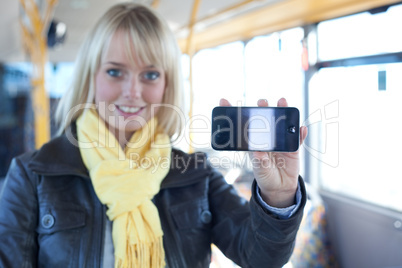 woman with a smartphone inside a bus