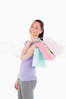 Good looking woman holding shopping bags while standing