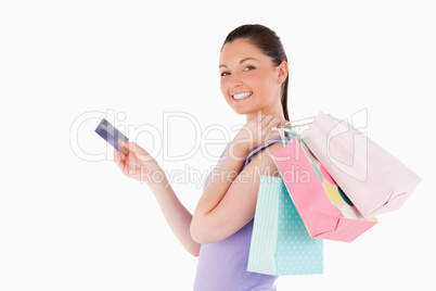 Attractive woman with a credit card holding shopping bags while