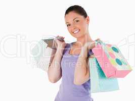 Gorgeous woman holding shopping bags while standing
