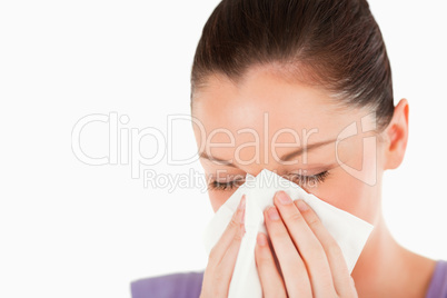 Portrait of an attractive woman sneezing while standing