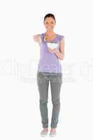 Beautiful woman holding a bowl of salad while standing