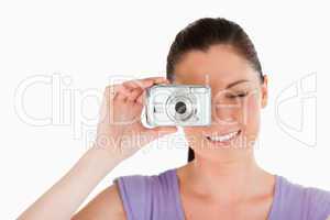 Portrait of a beautiful woman using a camera while standing