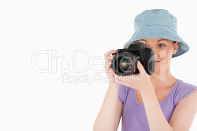 Lovely female using a camera while standing Lovely female using a camera while standing