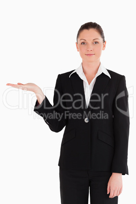 Attractive woman in suit showing a copy space while standing