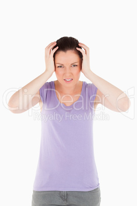 Charming woman having a migraine while standing