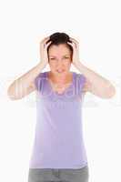 Charming woman having a migraine while standing