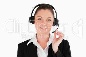 Portrait of a beautiful woman in suit using headphones and posin