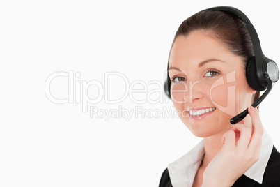 Portrait of a gorgeous woman in suit using headphones and posing