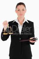 Pretty woman in suit holding scales of justice and a gavel