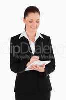 Portrait of a beautiful woman in suit writing on a notebook