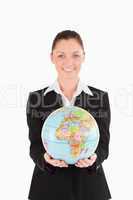 Pretty woman in suit holding a globe