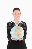 Beautiful woman in suit holding a globe