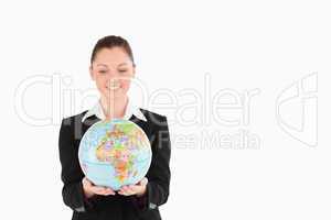 Attractive woman in suit holding a globe