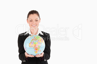 Good looking woman in suit holding a globe