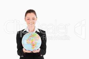 Good looking woman in suit holding a globe