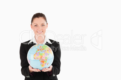 Charming woman in suit holding a globe