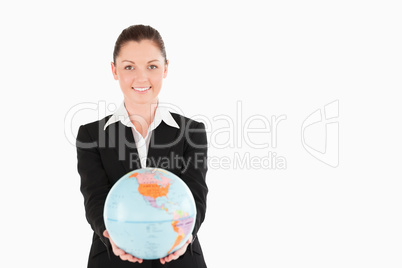 Gorgeous woman in suit holding a globe