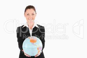 Gorgeous woman in suit holding a globe