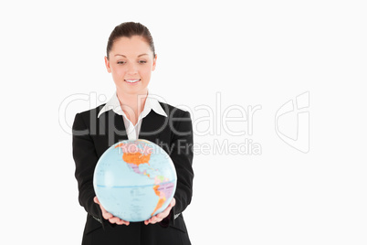 Cute woman in suit holding a globe