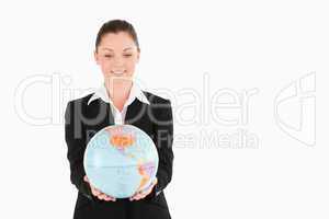 Cute woman in suit holding a globe