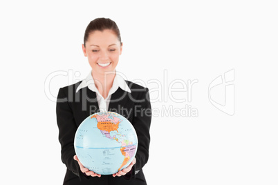 Lovely woman in suit holding a globe