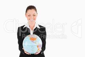 Lovely woman in suit holding a globe